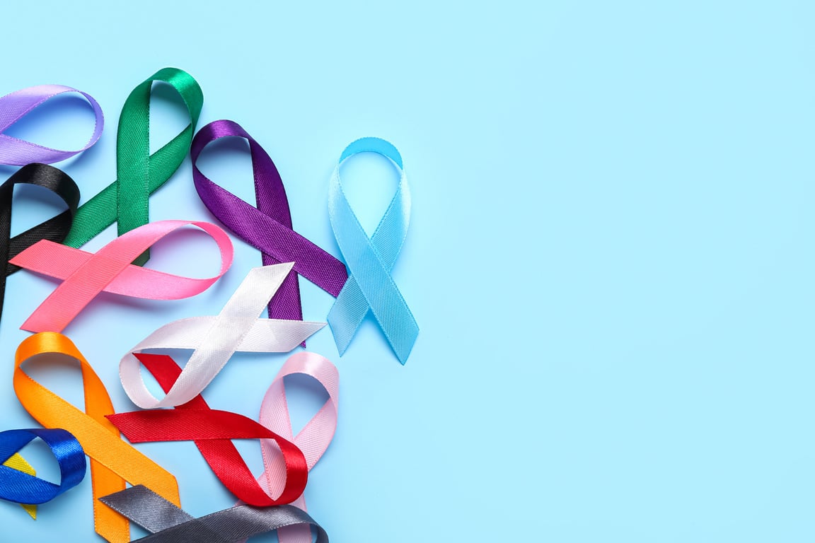 Colorful Awareness Ribbons on Blue Background. World Cancer Day